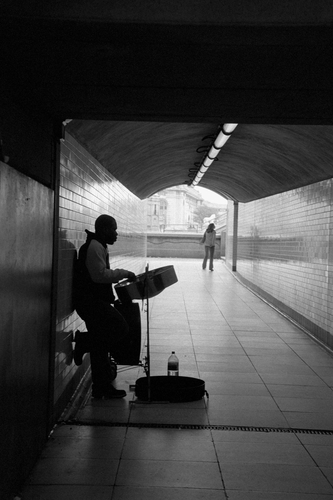 A busker in Westminster subway. Photographed by Barbara Chandler in 2006 Sonic Editions print