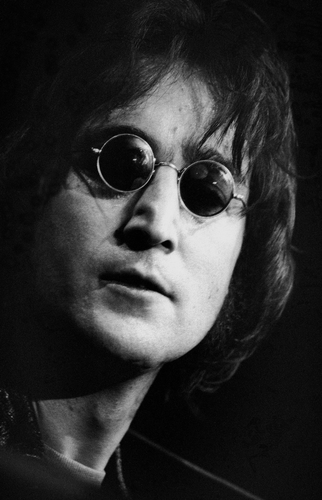 A close up of John Lennon performing on stage in 1971.