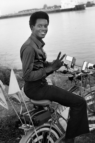 A young man on his bicycle by the banks of the Mississippi