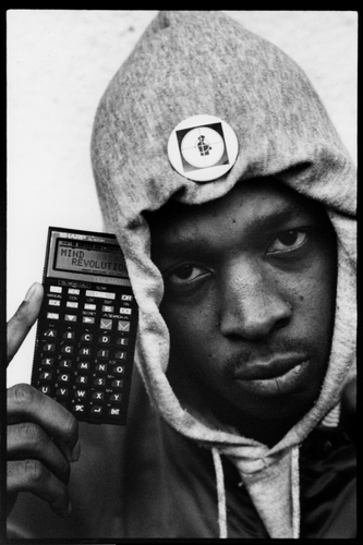 Chuck D of Public Enemy photographed in London in 1987 holding a personal organiser that spells out Mind Revolution.